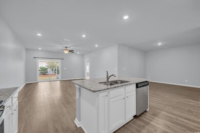 Kitchen with a center island with sink, a sink, li