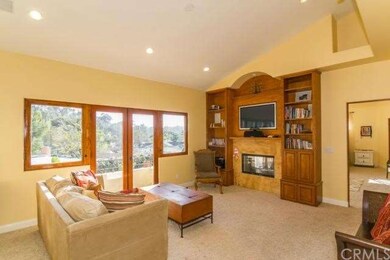 Family room/den upstairs with built-ins and a fire