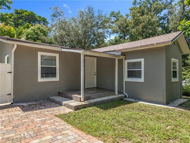 Entrance to property featuring a yard and stucco siding