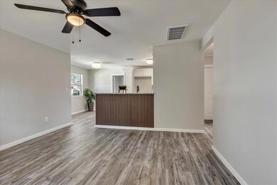 Unfurnished living room with dark wood-type flooring and ceiling fan