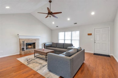 Living area featuring wood finished floors, visibl