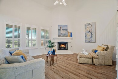 Living area with ceiling fan, wood finished floors