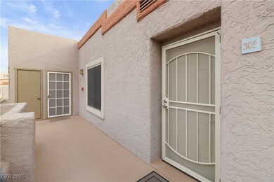 Entrance to property with stucco siding and a patio area
