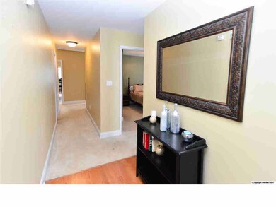 THE FOYER OFFERS LAMINATE HARDWOOD FLOORS AND SMOOTH CEILINGS.