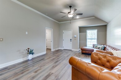 Living room featuring crown molding, lofted ceiling, ceiling fan, and hardwood / wood-style floors, lifted plug for wall mount TV