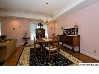 Open dining room with large windows & hardwood flo