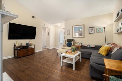 Living area featuring lofted ceiling and wood finished floors