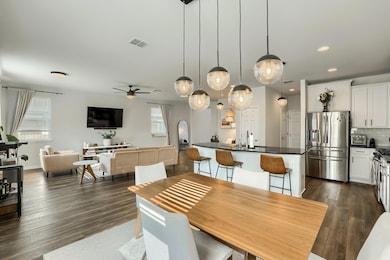 Dining area featuring ceiling fan, dark wood-styl