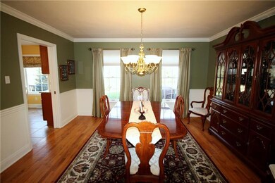 The dining room features hardwood floors and chair