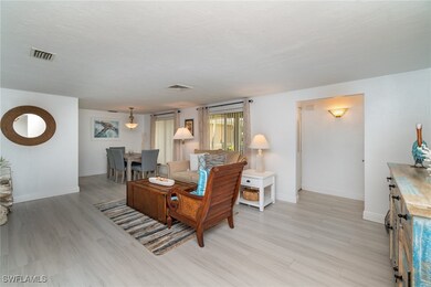 Living room with light hardwood / wood-style floor