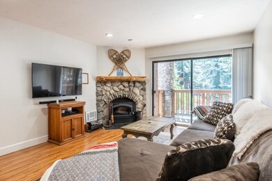 Living area featuring a fireplace, light wood finished floors, and recessed lighting