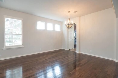 Unfurnished room with visible vents, dark wood fi