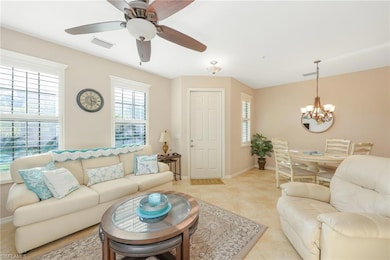 Living room with light tile patterned floors and c