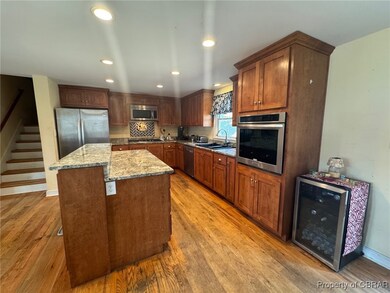 Kitchen featuring  a kitchen island, light stone c
