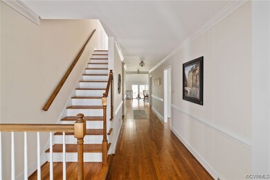 Beautiful hardwood floors, crown moulding, and cha