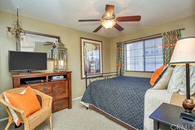 Inviting bedroom features include mirrored wardrobe doors and ceiling fan