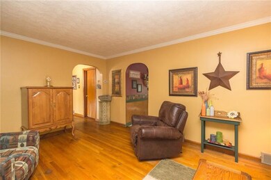 Living room open to the kitchen and hallway to bed
