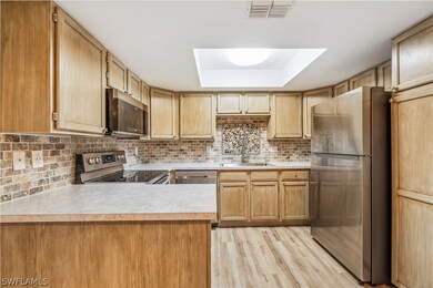 Kitchen featuring tasteful backsplash, sink, appli