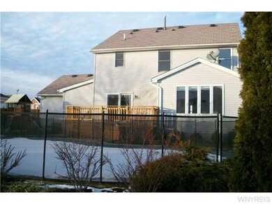 Exterior Back. Child safety fence surrounds in gro