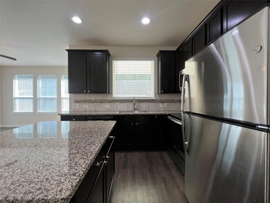 Kitchen with stainless steel appliances, light st