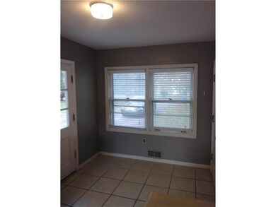 Dining space in kitchen; windows facing driveway &