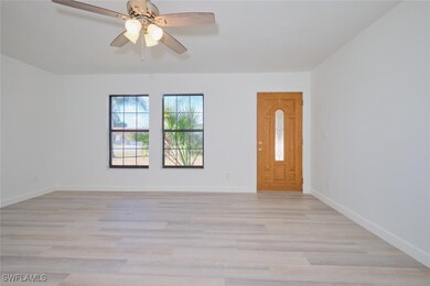 Empty room featuring ceiling fan and light wood-ty