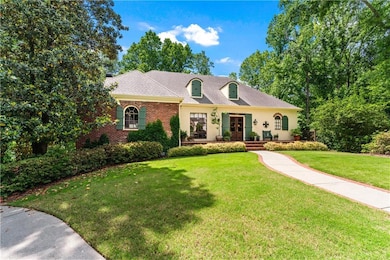 View of front of house featuring a front lawn, bri
