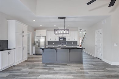 Kitchen with stainless steel appliances, including