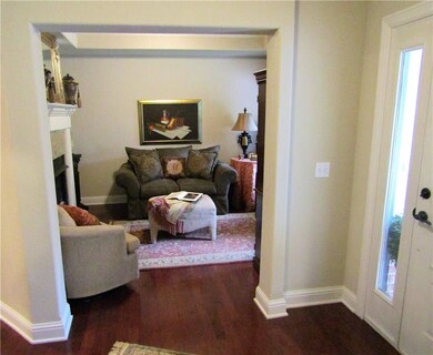 Very cozy sitting/dining room with a double sided gas log fireplace!