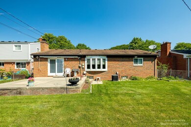 Fenced-in back yard with patio area