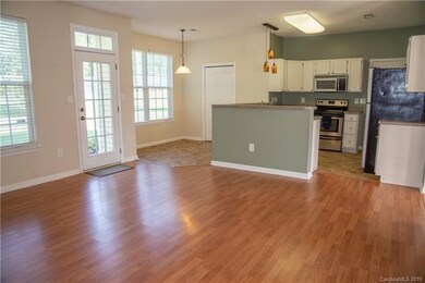Den, breakfast area and kitchen.
