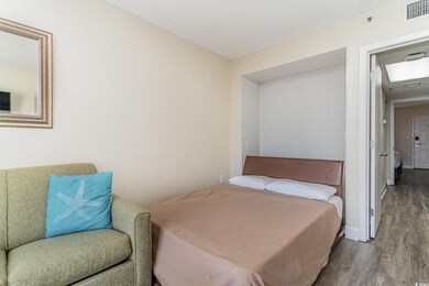 Bedroom with hardwood / wood-style flooring