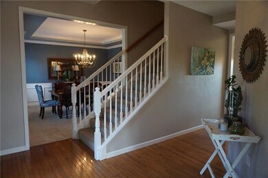 Beautiful Sunlit entry with hard wood floors and 9