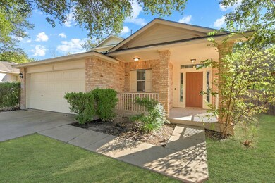 View of front facade featuring covered porch, brick siding, concrete driveway, a front lawn, and a garage