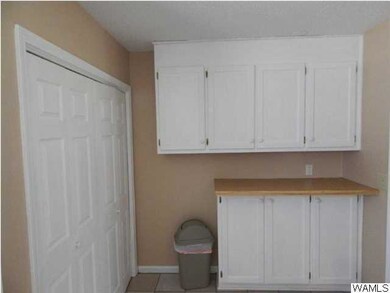 Extra kitchen counter and cabinet space.  Door to