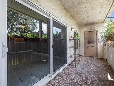 Covered patio area with tiled flooring, perfect fo
