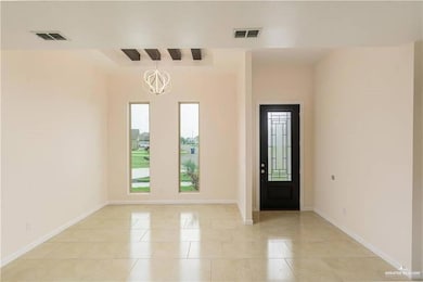 Foyer featuring a chandelier and light tile patterned flooring