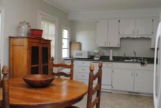 Adorable kitchen with access to the back yard