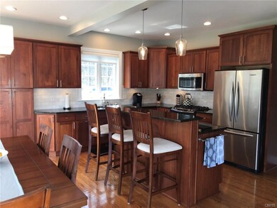 Cherry kitchen with granite counters and natural s