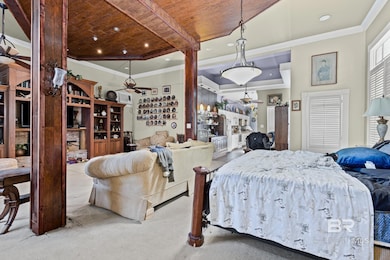 Bedroom with crown molding and carpet floors