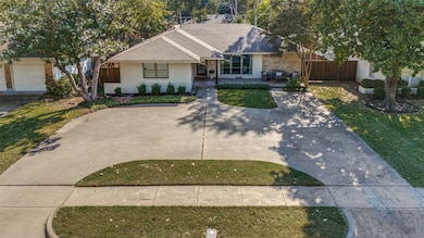 Spacious circle drive perfect for pickleball, basketball and parking.