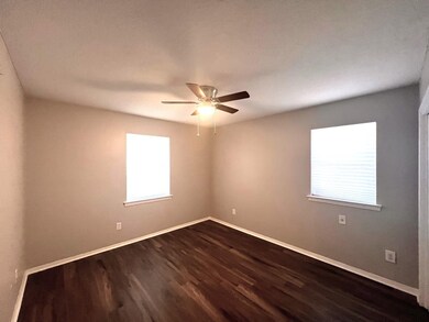 Spare room featuring wood-type flooring and ceiling fan