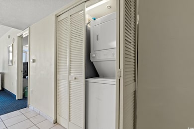 Clothes washing area with stacked washer and cloth