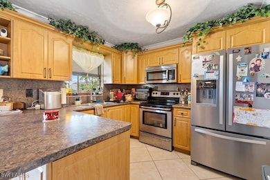 Kitchen with ornamental molding, appliances with s