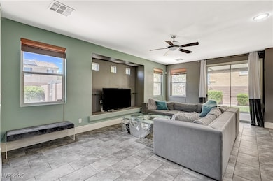 Living area featuring ceiling fan, baseboards, rec