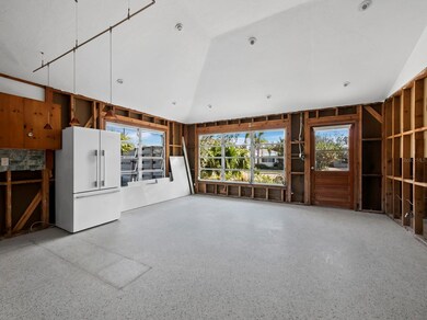 Current - Large open space with vaulted ceilings, recessed lighting and terrazzo floors