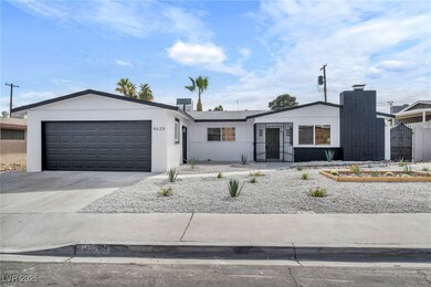 View of front of property with a garage and drivew