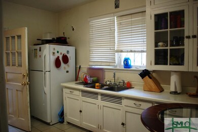 Kitchen. Kitchen door accesses a latticed rear por
