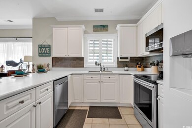 Kitchen with light tile patterned flooring, crown 