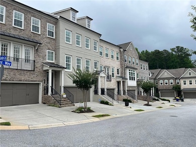 Townhome / multi-family property with brick siding, a residential view, and concrete driveway